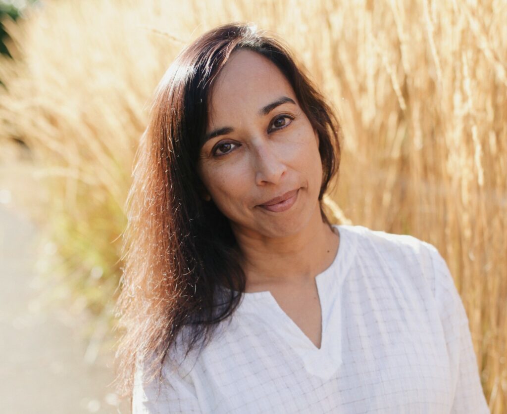 The author standing in front of tall golden grasses