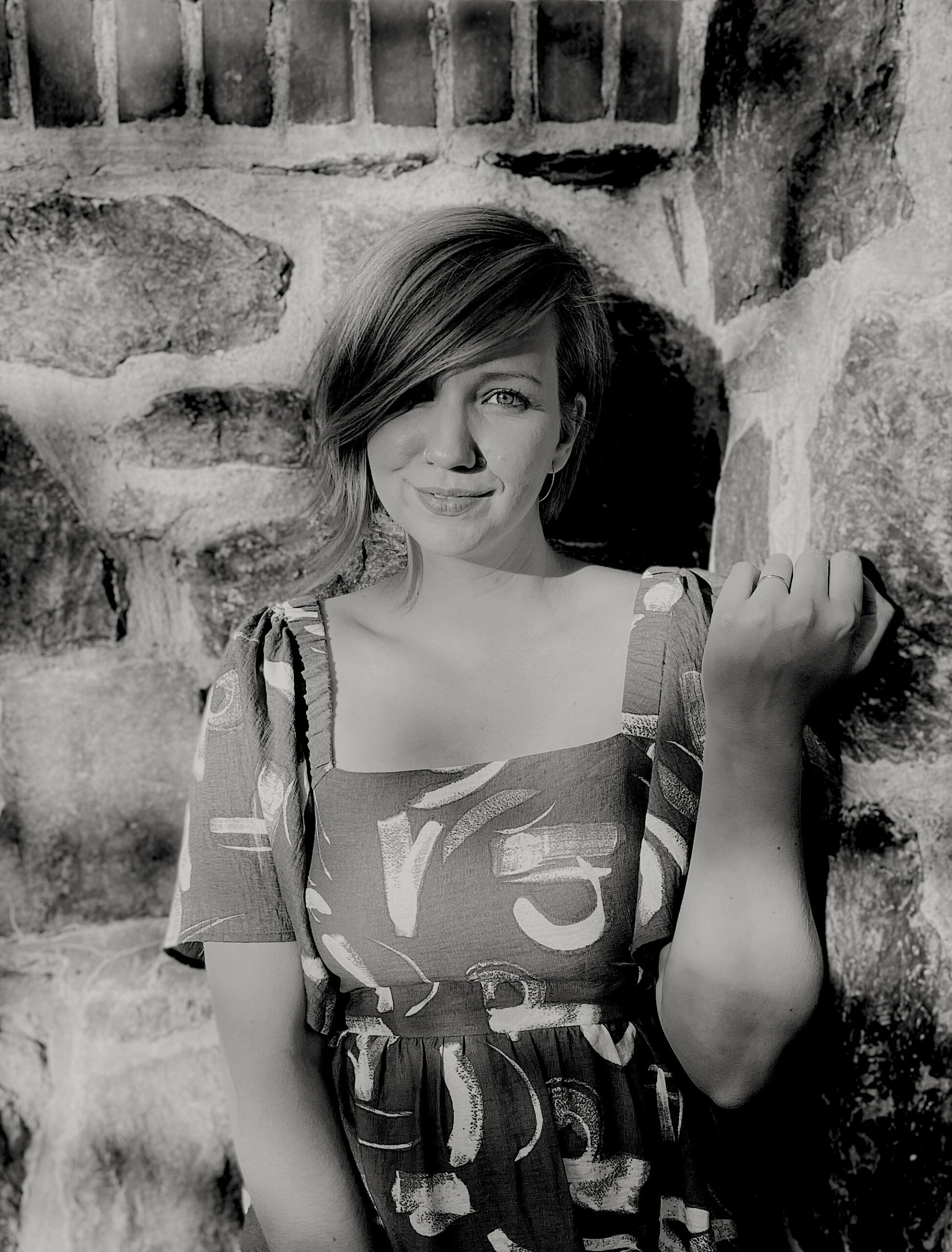 Black and white photograph of a woman with short hair wearing a dress.